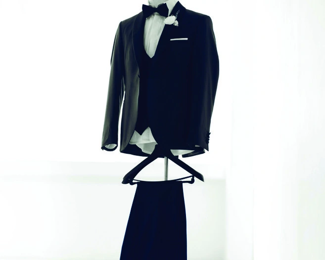 A carefully arranged dinner jacket, waistcoat and trousers in the atelier
